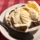 Indian pudding in bowl on red tablecloth